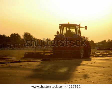 Tractor work on the beach in early morning