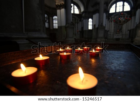 Votive candles on an ancient holder of \