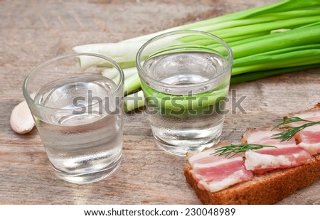 glass of vodka, onions and bacon sandwich
