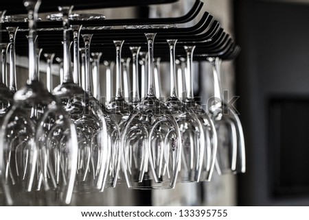 Glasses hanging over a bar rack