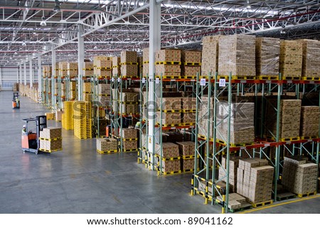 Fork lifter work in big warehouse