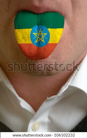 man with open mouth spreading tongue colored in ethiopia flag as symbol of values like teaching, learning, multilingual speaking of different languages