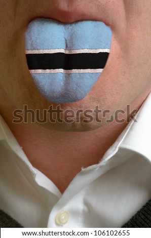 man with open mouth spreading tongue colored in botswana flag as symbol of values like teaching, learning, multilingual speaking of different languages