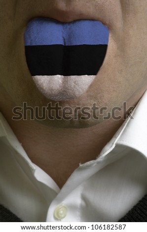 man with open mouth spreading tongue colored in estonia flag as symbol of values like teaching, learning, multilingual speaking of different languages