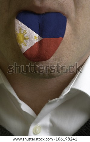 man with open mouth spreading tongue colored in philippines flag as symbol of values like teaching, learning, multilingual speaking of different languages
