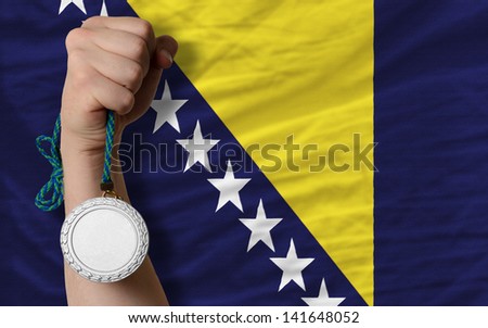 Holding silver medal for sport and national flag of bosnia herzegovina