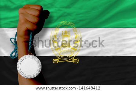 Holding silver medal for sport and national flag of afghanistan