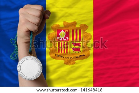 Holding silver medal for sport and national flag of andorra