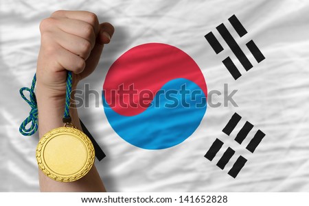 Winner holding gold medal for sport and national flag of south korea