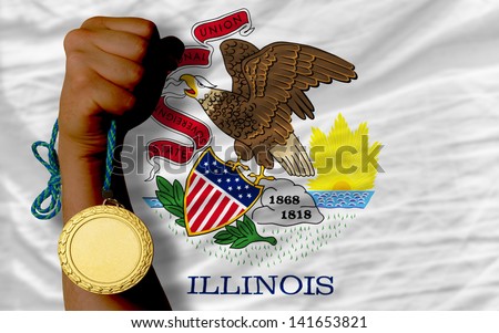 Winner holding gold medal for sport and flag of us state of illinois