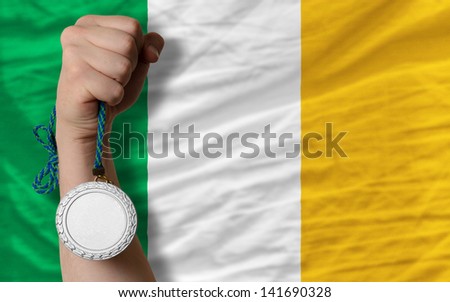 Holding silver medal for sport and national flag of ireland