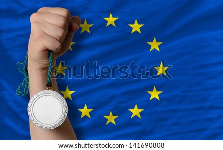 Holding silver medal for sport and national flag of europe
