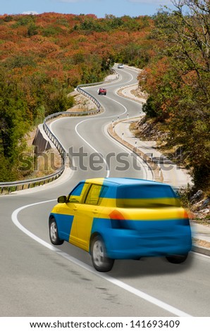 traveling car in national flag of sweden colors and beautiful road landscape for tourism and touristic adertising