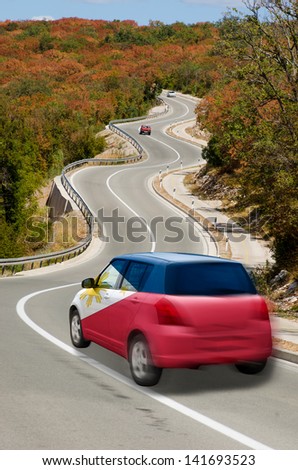 traveling car in national flag of philippines colors and beautiful road landscape for tourism and touristic adertising