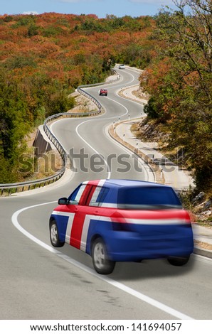 traveling car in national flag of iceland colors and beautiful road landscape for tourism and touristic adertising
