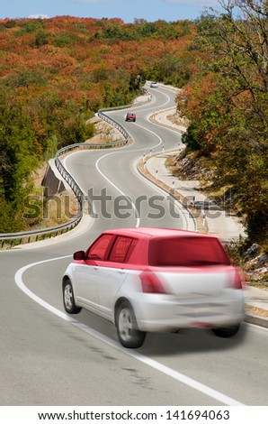 traveling car in national flag of indonesia colors and beautiful road landscape for tourism and touristic adertising