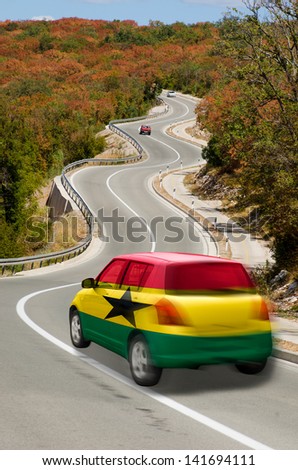 traveling car in national flag of ghana colors and beautiful road landscape for tourism and touristic adertising