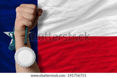 Holding silver medal for sport and flag of us state of texas