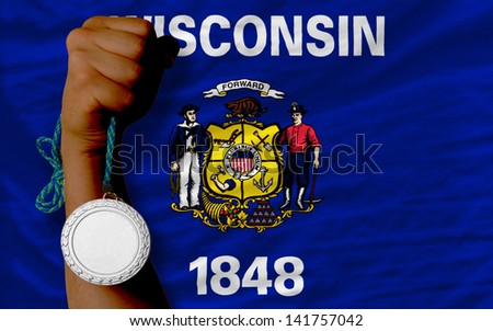 Holding silver medal for sport and flag of us state of wisconsin