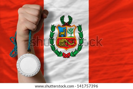 Holding silver medal for sport and national flag of peru