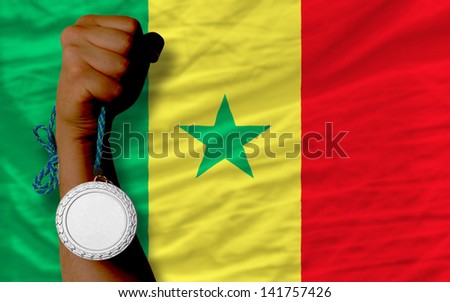 Holding silver medal for sport and national flag of senegal