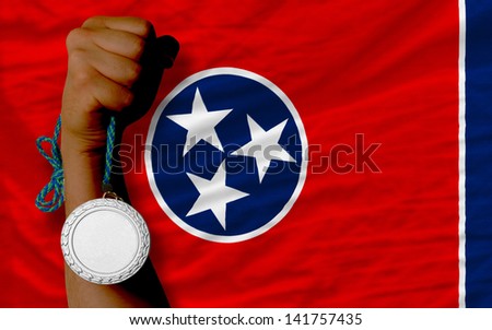 Holding silver medal for sport and flag of us state of tennessee