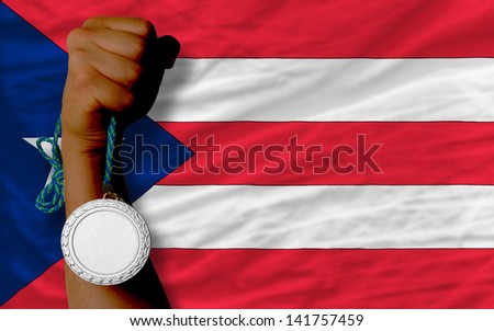 Holding silver medal for sport and national flag of puertorico