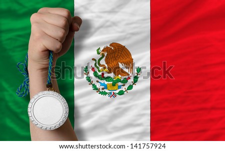 Holding silver medal for sport and national flag of mexico
