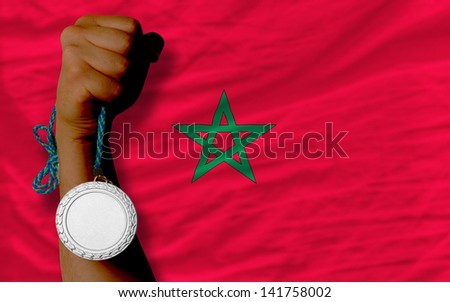 Holding silver medal for sport and national flag of morocco