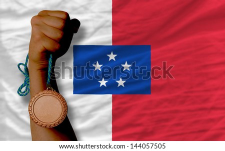 Holding bronze medal for sport and national flag of  franceville
