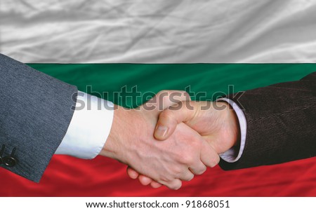 businessmen handshake after good deal in front of bulgaria flag