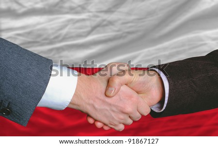 two businessmen shaking hands after good business investment  agreement in portugal, in front of flag