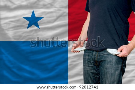 poor man showing empty pockets in front of panama flag