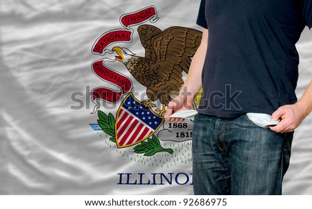 poor man showing empty pockets in front of american state of illinois flag