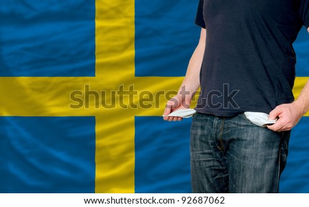 poor man showing empty pockets in front of sweden flag