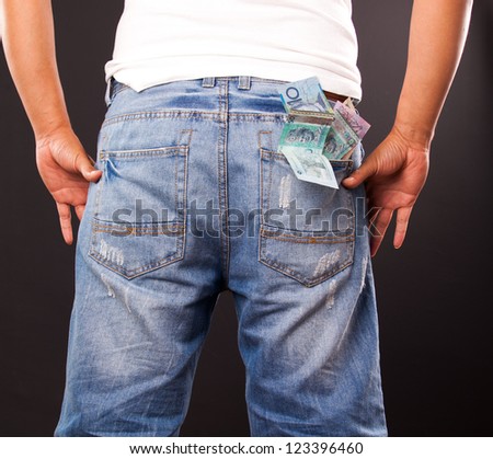 man with money exposed  in pocket