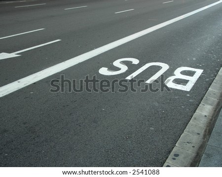 Road signs on asphalt, bus lane, fast lanes