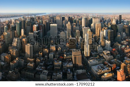 Aerial panoramic view over Manhattan from Empire State building top, New York. Sunset of a clear, sunny day.