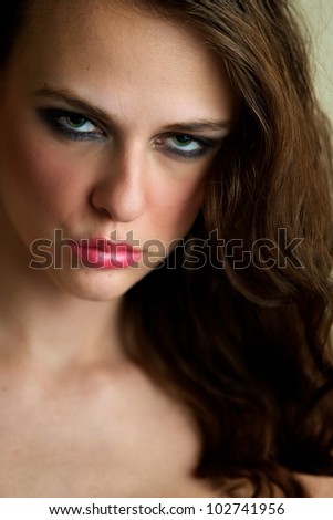 Attractive female gazing into the camera, serious expression