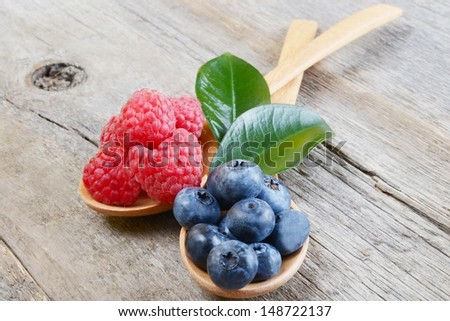 Berries on Wooden Background. Summer or Spring Organic Berry over Wood. Raspberries, Blueberry. Agriculture, Gardening, Harvest Concept