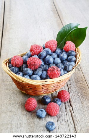 Berries on Wooden Background. Summer or Spring Organic Berry over Wood. Raspberries, Blueberry. Agriculture, Gardening, Harvest Concept
