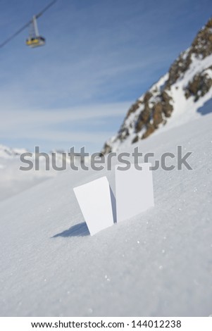 Two blank winter sport ski pass tickets with mountain cable car and scenic background. Concept to illustrate wWinter sport admission fee
