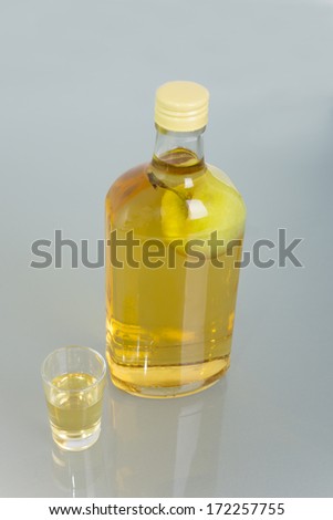 Apple inside bottle filled with alcoholic beverage