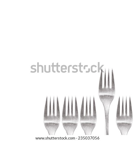 fork standing out of the crowd cutlery isolated on white