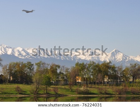Traveling: Plane flying over Central Asia mountainscape