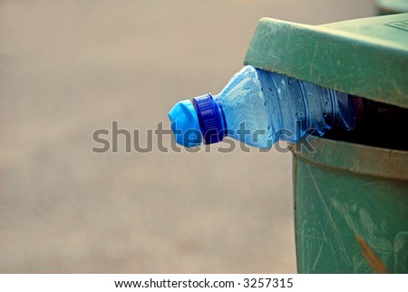 Water Bottle in Garbage or Recycling Can