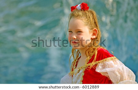 Girl in Fancy Princess Dress with Waterfall in Background