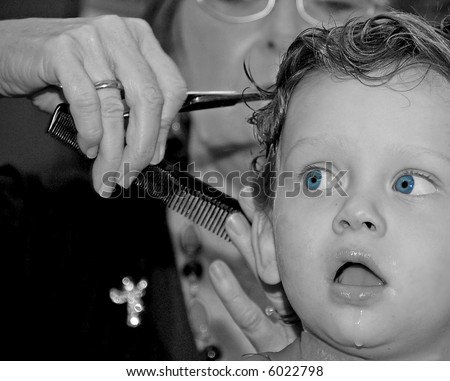 Young Boy Getting Haircut With Funny Stare