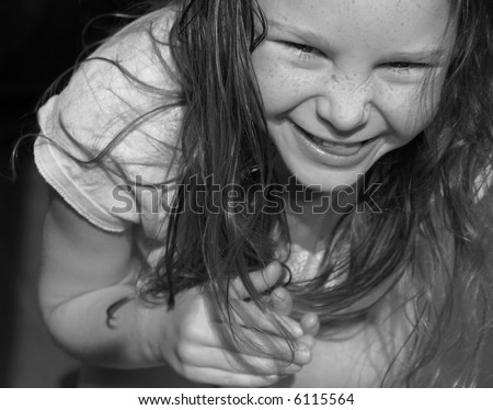 stock photo Freckle Faced Girl With Scrunched Up Nose While Bending Over