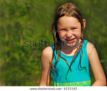 stock photo Young Girl In Bathing Suit Soaked From Water Play